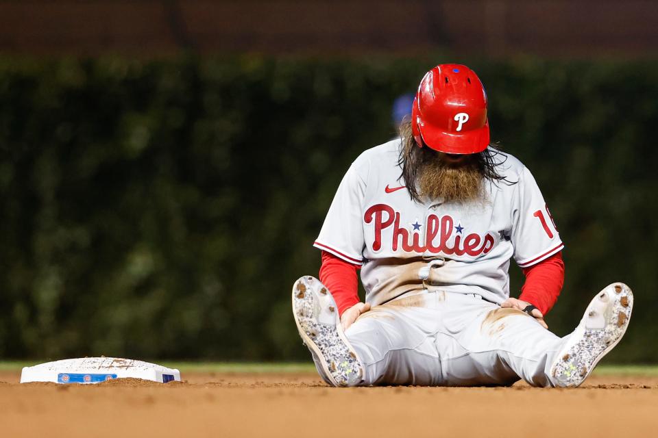 Phillies outfielder Brandon Marsh sits on the field after being tagged out at second base against the Cubs.