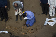 FILE - In this Dec. 14, 2010, file photo, then Japanese Prime Minister Naoto Kan bows at a mass grave site on Iwo Jima island where officials discovered the remains of Japanese soldiers who died in the battle for Iwo Jima. Seventy-five years after the end of World War II, more than 1 million Japanese war dead are scattered throughout Asia, where the legacy of Japanese aggression still hampers recovery efforts. The missing Japanese make up about half of the 2.4 million soldiers who died overseas during Japan’s military rampage across Asia in the early 20th century.(AP Photo/David Guttenfelder, File)