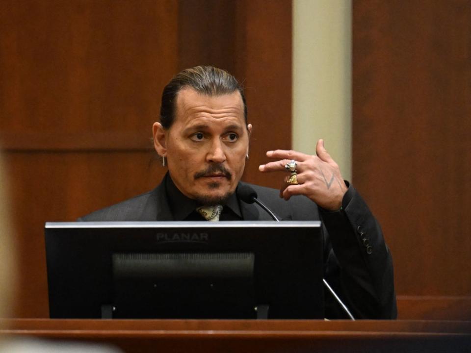 Depp testifying during his defamation trial on 19 April 2022 (POOL/AFP via Getty Images)