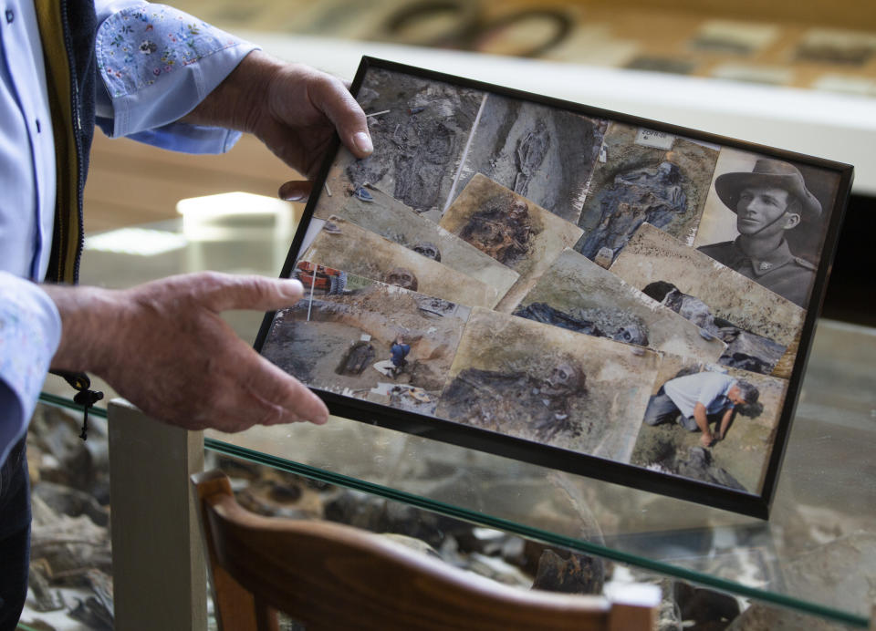 Amateur archeologist Johan Vandewalle shows photos of the discovery of the body of Australian World War I soldier John "Jack" Hunter, at his cafe in Zonnebeke, Belgium, Thursday, April 22, 2021. On another Anzac Day turned lonesome by the global pandemic, solitary actions show all the more how the sacrifices of Australia and New Zealand during World War I are far from forgotten. While global attention will turn at dawn on Sunday to the beaches of Turkey’s Gallipoli where the two emerging countries crafted a sense of nationhood from the horrors of war in April 1915, all along the front line in Europe, small ceremonies will show gratitude over a century after the war ended. (AP Photo/Virginia Mayo)