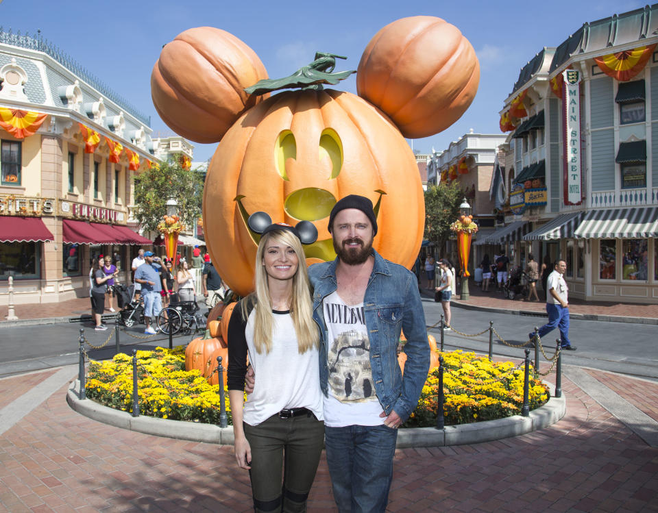 In this publicity photo released by Disneyland, Emmy-nominated actor Aaron Paul, right, and wife, Lauren Parsekian, celebrate "Halloween Time" at Disneyland on Tuesday, Sept. 17, 2013, in Anaheim, Calif. The "Halloween Time" celebration at the Disneyland Resort, which features special attractions and entertainment, continues through October 31, 2013. (AP Photo/Disneyland, Paul Hiffmeyer)