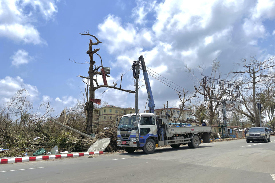 Electrical staff rebuilt lamp-posts damaged by Cyclone Mocha in Sittwe township, Rakhine State, Myanmar, Friday, May 19, 2023. Cyclone Mocha roared in from the Bay of Bengal on Sunday with high winds and rain slamming a corner of neighboring Bangladesh and a wider swath of western Myanmar's Rakhine state. (AP Photo)