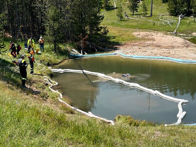 An SUV is pulled from the inactive Semi-Centennial Geyser in the Wyoming area of Yellowstone National Park on Friday.