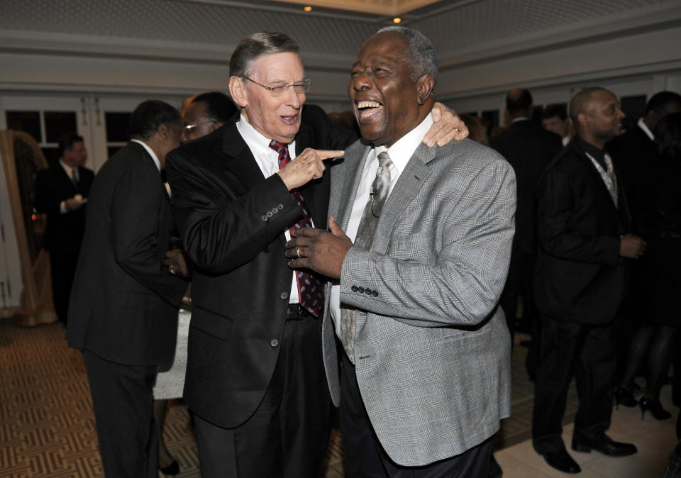 Baseball Hall of Famer Hank Aaron, right, laughs as he talks with baseball Commissioner Bud Selig, left, at a reception for Aaron, Friday, Feb. 7, 2014, in Washington. Aaron turned 80 this week and is being celebrated with a series of events in Washington. (AP Photo/Nick Wass)