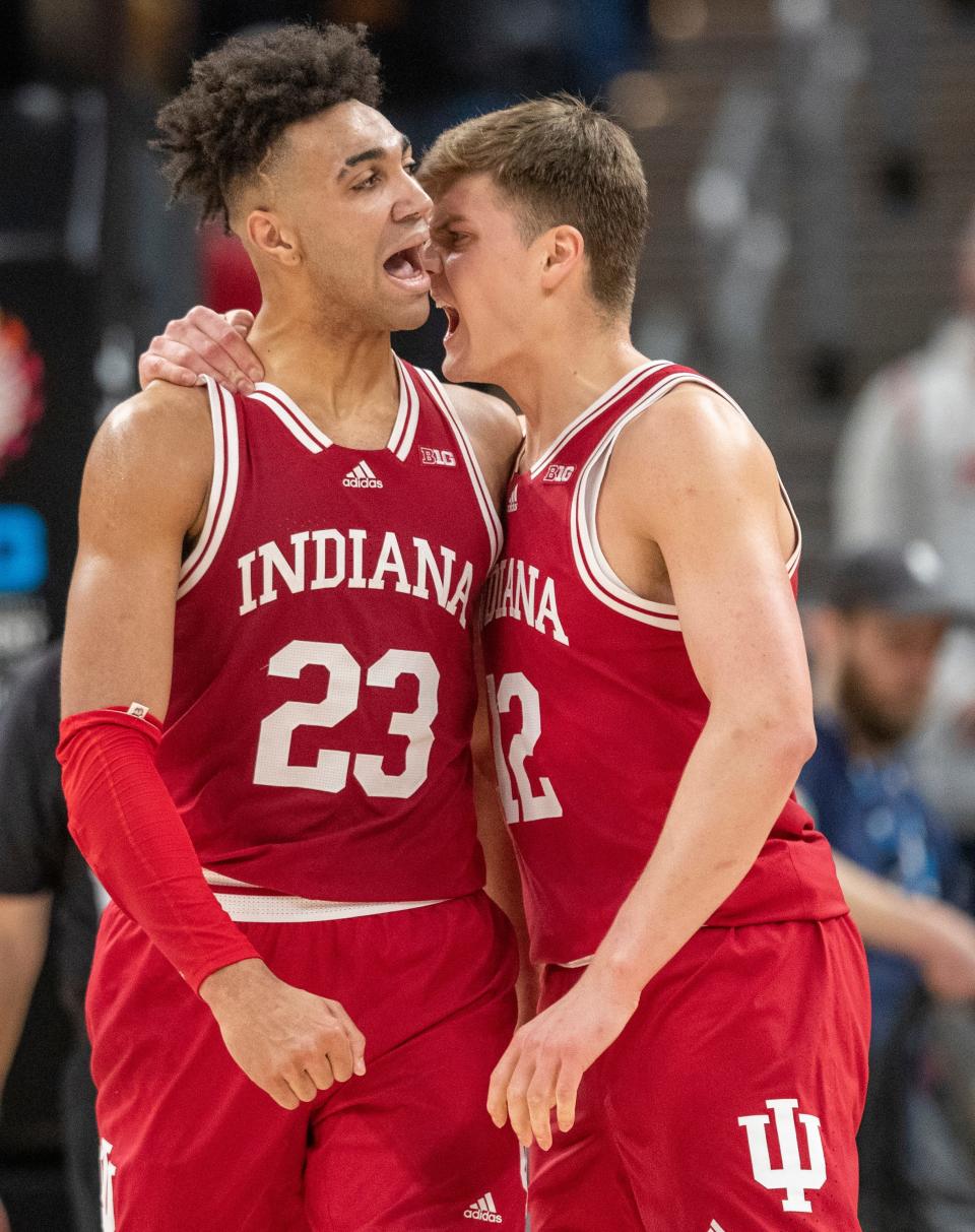 Indiana Hoosiers forward Trayce Jackson-Davis (23) and Indiana Hoosiers forward Miller Kopp (12) yell as they embrace during a big Hoosiers run, Thursday, March 10, 2022, during Big Ten tournament men’s action from Indianapolis’ Gainbridge Fieldhouse. Indiana won 74-69. 