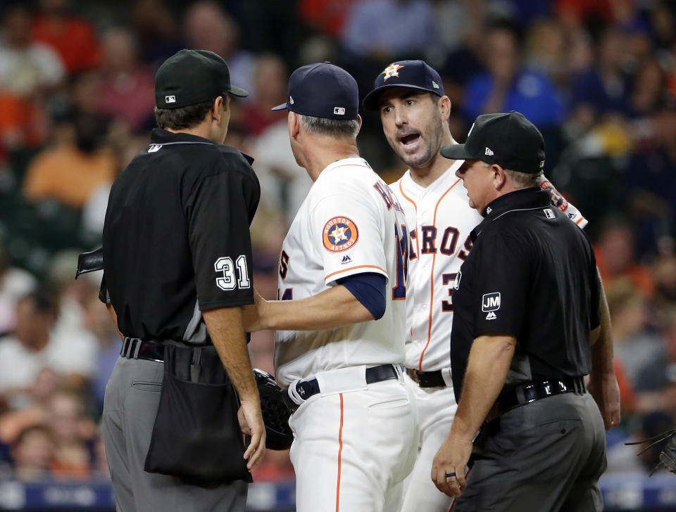 Houston Astros starting pitcher Justin Verlander, facing, argues with home plate umpire Pat Hoberg (31) as A.J. Hinch and first base umpire Greg Gibson get between them after Hoberg ejected Verlander during the sixth inning of a baseball game Tuesday, Aug. 27, 2019, in Houston. (AP Photo/Michael Wyke)