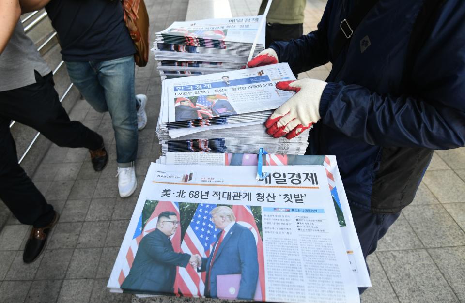 <p>A South Korean newspaper deliveryman collects newspapers in Seoul reporting the summit between President Donald Trump and North Korean leader Kim Jong Un on June 12, 2018. (Photo: Jung Yeon-je/AFP/Getty Images) </p>