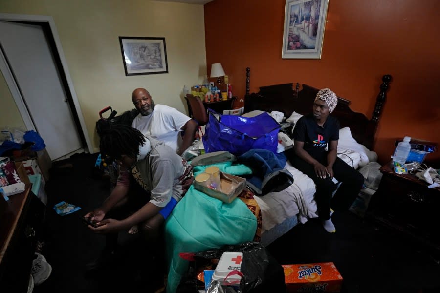 Ida Cartlidge, right, her son Jakavien Cartlidge, left, and husband Charles Jones, who were injured while inside their mobile home when it was destroyed by a deadly tornado, talk about their experience in their room in the Rolling Fork Motel, where they are now living, in Rolling Fork, Miss., Tuesday, May 9, 2023. “It sounded like a real loud train coming through,” Cartlidge said. “And I could feel the wind, it was so powerful you couldn’t even breathe while you were in the air. (AP Photo/Gerald Herbert)