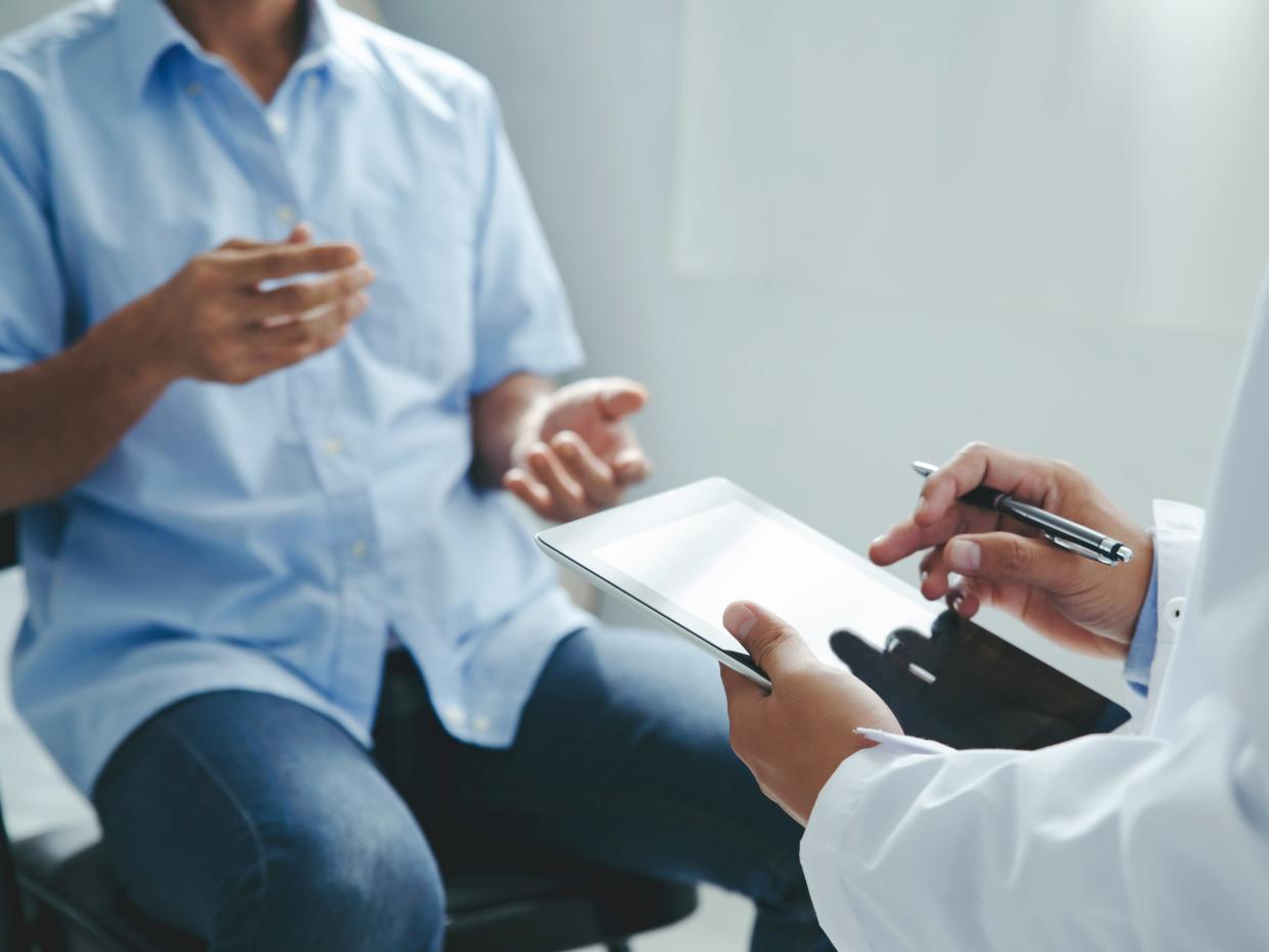 A stock image of a man talking to his doctor.