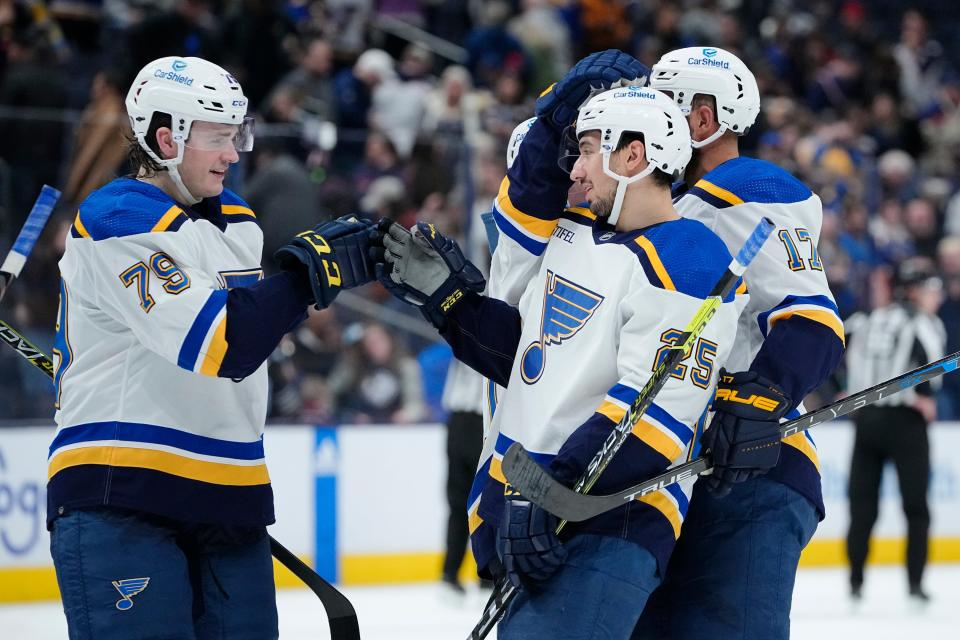 Mar 11, 2023; Columbus, Ohio, USA;  St. Louis Blues left wing Sammy Blais (79) and left wing Josh Leivo (17) congratulate center Jordan Kyrou (25), who had three goals in the game, following their 5-2 win over the Columbus Blue Jackets in the NHL hockey game at Nationwide Arena. Mandatory Credit: Adam Cairns-The Columbus Dispatch