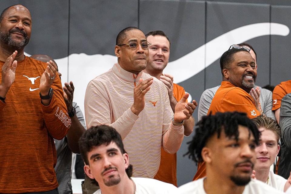 Texas men's basketball coach Rodney Terry applauds as the Longhorns are announced as a No. 7 seed during the Selection Sunday TV broadcast. They'll open up their NCAA Tournament on Thursday against the winner of Tuesday night's Virginia-Colorado State game.