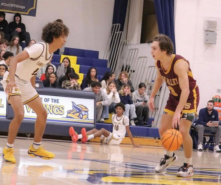Simi Valley's Ryder Mjoen (right) surveys the court during the Pioneers' 81-53 loss to host Campbell Hall in a CIF-SS Division 2AA first-round game on Wednesday, Feb. 7, 2024.