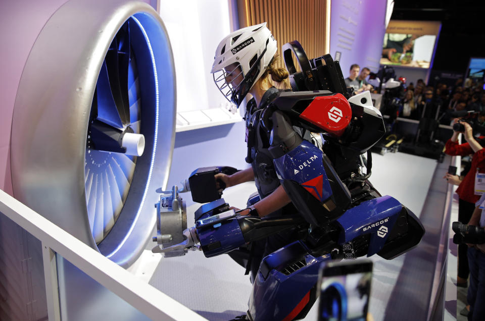 Tara Scranton demonstrates the Sarcos Robotics Guardian XO at the Delta Airlines booth during the CES tech show, Wednesday, Jan. 8, 2020, in Las Vegas. The full-body powered exoskeleton is designed to boost the user's strength and endurance. (AP Photo/John Locher)