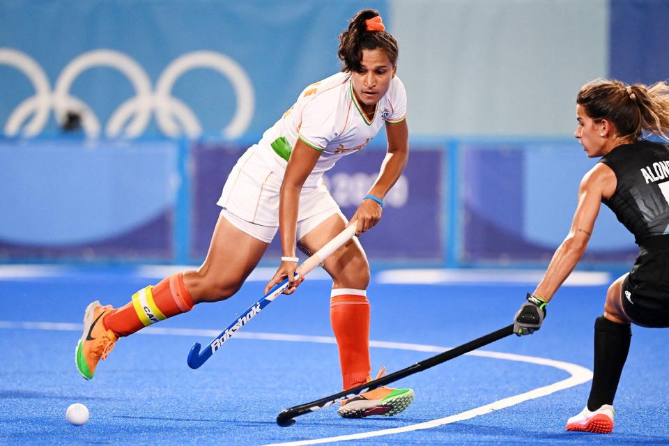 India's Rani (L) is tackled by Argentina's Agostina Alonso during their women's semi-final match of the Tokyo 2020 Olympic Games field hockey competition, at the Oi Hockey Stadium in Tokyo, on August 4, 2021.