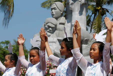 Schoolgirls perform during the 50th anniversary of the My Lai massacre in My Lai village, Vietnam March 16, 2018. REUTERS/Kham