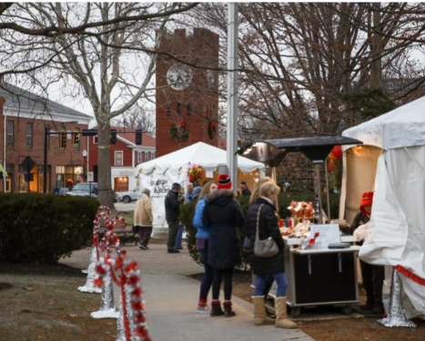 Visitors visit booths during a previous Christkindlmarkt in downtown Hudson. This year's event will be Dec. 9-11.