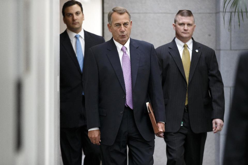 House Speaker John Boehner of Ohio walks to a GOP caucus on Capitol Hill in Washington, Wednesday, April 2, 2014. House Republicans are crafting a plan to try to balance the budget within 10 years. (AP Photo/J. Scott Applewhite)