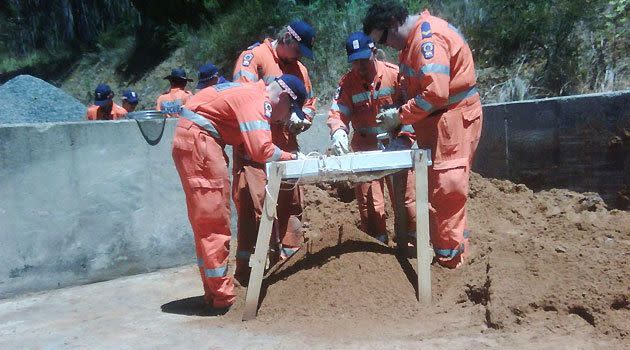 SES crews sifting through garden loam at the Mount Lofty Botanic Gardens, in the Adelaide Hills, today.