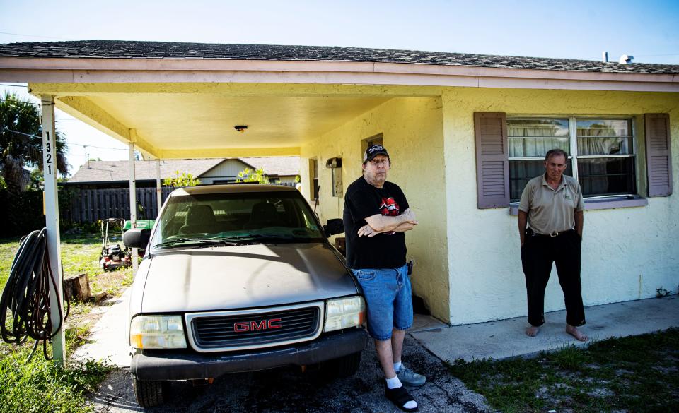 Lifelong Naples residents and brothers Tommas, 56,  and Todd Murray, 59, stand for a portrait outside the duplex they rent in Naples on Tuesday, June 7, 2022. They say the duplex has been sold and that they have to be out by July 31. Tommas is on disability and Todd has a full time job at a local market. They say they can’t afford another place to live because the rents are too high and  that the ones they can afford don’t take pets. Tommas has a cat. They are afraid that they may become homeless.   