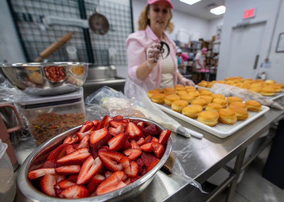 Chopped up strawberries wait to become strawberry shortcake back in the kitchen of Decked Out Donuts, north of Hanover. Amy Lovisone hand rolls and cuts the dough she makes in the store's kitchen. 