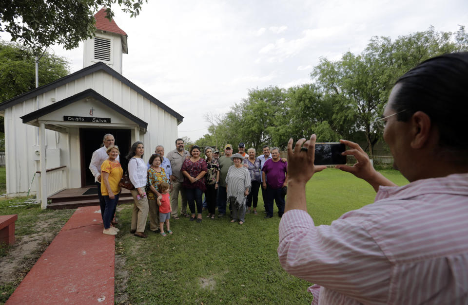 In this Wednesday May 1, 2019, photo, descendants of Nathaniel Jackson pose for a photo at the Jackson Ranch in Pharr, Texas. The family has hired lawyers and lobbied the U.S. government to spare their ancestral property from a border wall, which work crews are expected to start building nearby in the coming weeks. (AP Photo/Eric Gay)