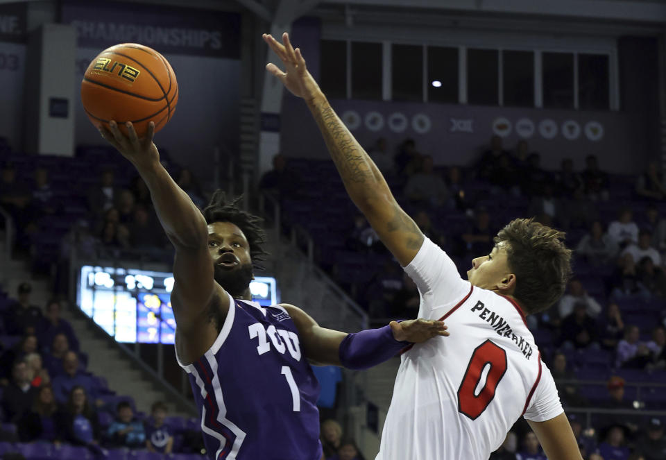 TCU guard Mike Miles Jr. (1) puts up a shot against Lamar guard Cody Pennebaker (0) in the second half during an NCAA college basketball game Friday, Nov. 11 2022, in Fort Worth, Texas. (AP Photo/Richard W. Rodriguez)
