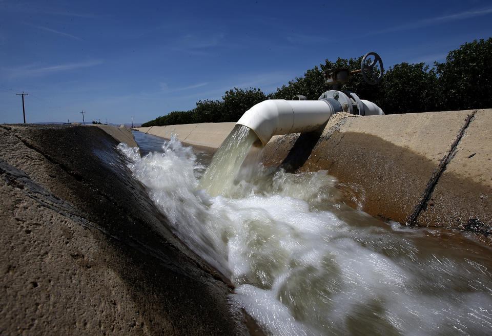 Water is pumped into an irrigation canal at an almond orchard in Firebaugh, California. It takes 3.2 gallons of water to grow just a single almond. (Photo: Justin Sullivan via Getty Images)