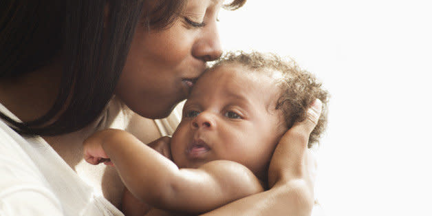 Mother kissing and hugging baby