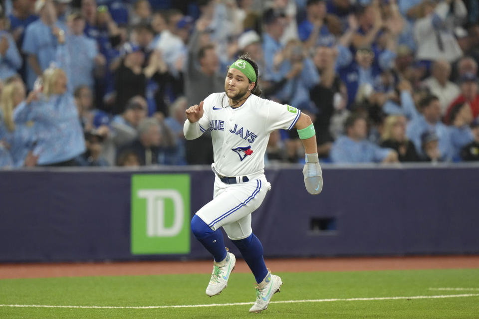Toronto Blue Jays' Bo Bichette closes in on home plate to score off a two-run home run by Cavan Baggio against the Tampa Bay Rays during the fourth inning of a baseball game Friday, Sept. 29, 2023, in Toronto. (Chris Young/The Canadian Press via AP)