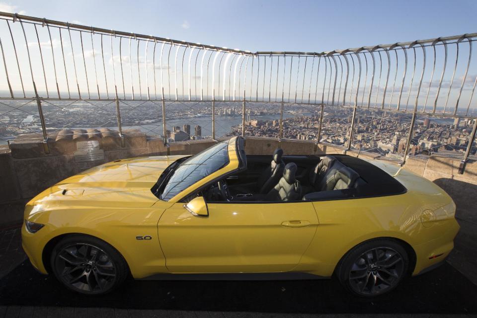 Ford Motor Co. introduces the all-new 2015 Mustang convertible on the 86th floor observation deck of the Empire State Building during the New York International Auto Show, Wednesday, April 16, 2014, in New York. (AP Photo/John Minchillo)