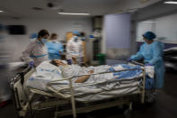 A COVID-19 patient is transferred to the "red zone," an area reserved for treating those suffering from COVID-19, in the Severo Ochoa Hospital in Leganes on the outskirts of Madrid, Spain, Wednesday, Feb. 17, 2021. (AP Photo/Bernat Armangue)