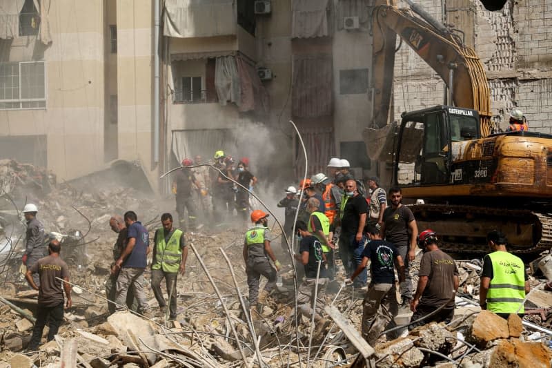 Civil Defense workers are seen at the site of the Israeli air raid attack in Beirut southern suburb. The death toll from the Israeli attack on Beirut's southern suburbs, a hotbed of the pro-Iranian Hezbollah movement, has risen to 31, authorities said on 21 September. Among the dead were three children and seven women, Lebanese Health Minister Firas Abiad said in a press conference. Marwan Naamani/dpa