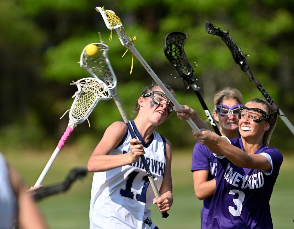 Tilly Crosby of Cape Cod Academy puts a shot on Martha's Vineyard goal defended by Charlotte Scott of Martha's Vineyard in June.