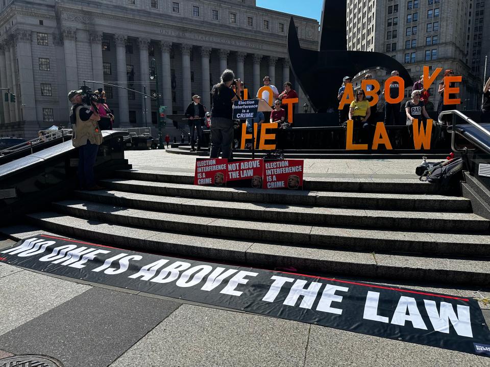 "No one is above the law." Trump protesters stand outside of Manhattan criminal court on April 15, 2024.