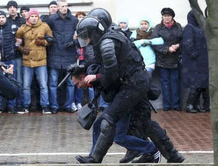 Law enforcement officers detain a man during a gathering, denouncing the new tax on those not in full-time employment and marking the 99th anniversary of the proclamation of the Belarussian People's Republic, in Minsk, Belarus, March 25, 2017. REUTERS/Vasily Fedosenko