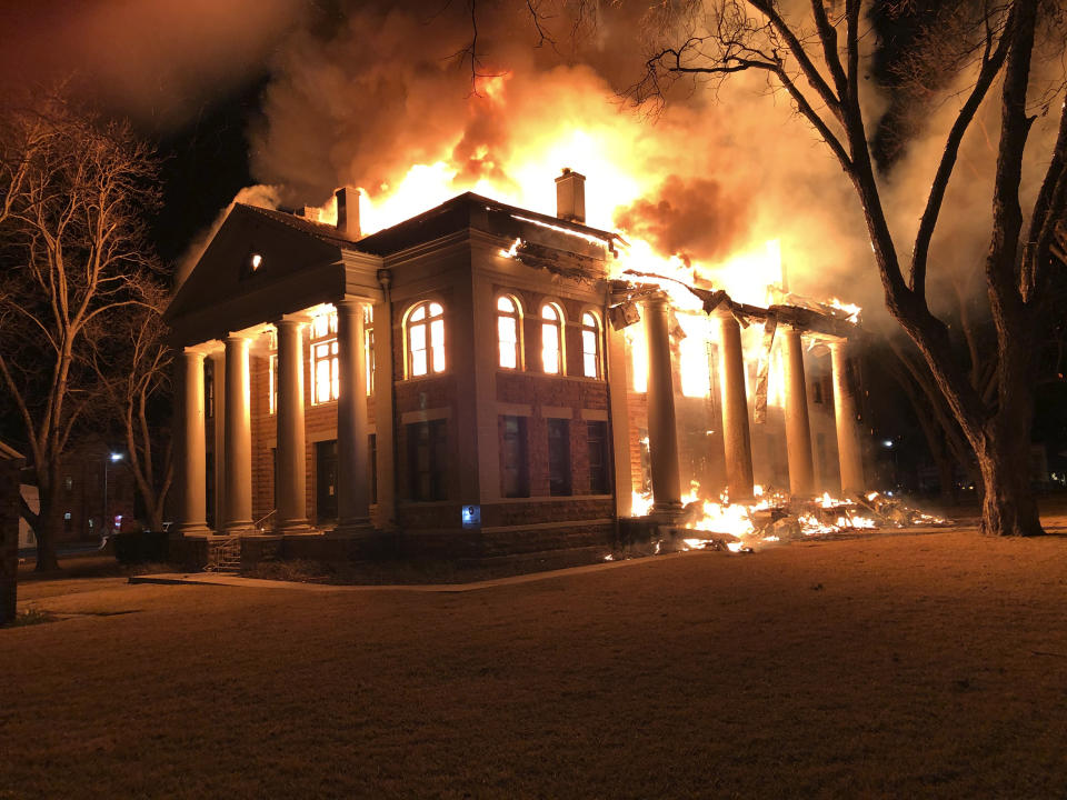 This photo provided by Mason County Judge Jerry Bearden shows a fire at the Mason County Courthouse, Thursday, Feb. 4, 2021, in Mason, Texas. An official says a suspect has been taken into custody following the massive fire that destroyed all but the rock outer walls of the 111-year-old courthouse. Fire investigators suspect arson in both the courthouse fire and a fire around the same time at a house about a mile away. (Mason County Judge Jerry Bearden via AP)