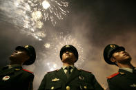 <p>Chinese paramilitary police officers stand next to the National Olympic Stadium, also known as the Bird’s Nest, during the opening ceremony of the Beijing 2008 Olympics on Aug. 8, 2008. (Photo: Oded Balilty/AP) </p>