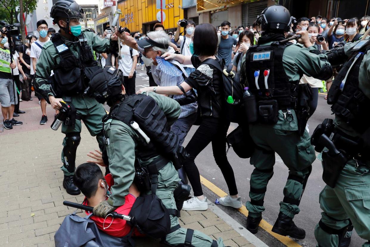 Anti-government demonstrators scuffle with riot police during a lunch time protest in Hong Kong, China, on May 27, 2020: REUTERS