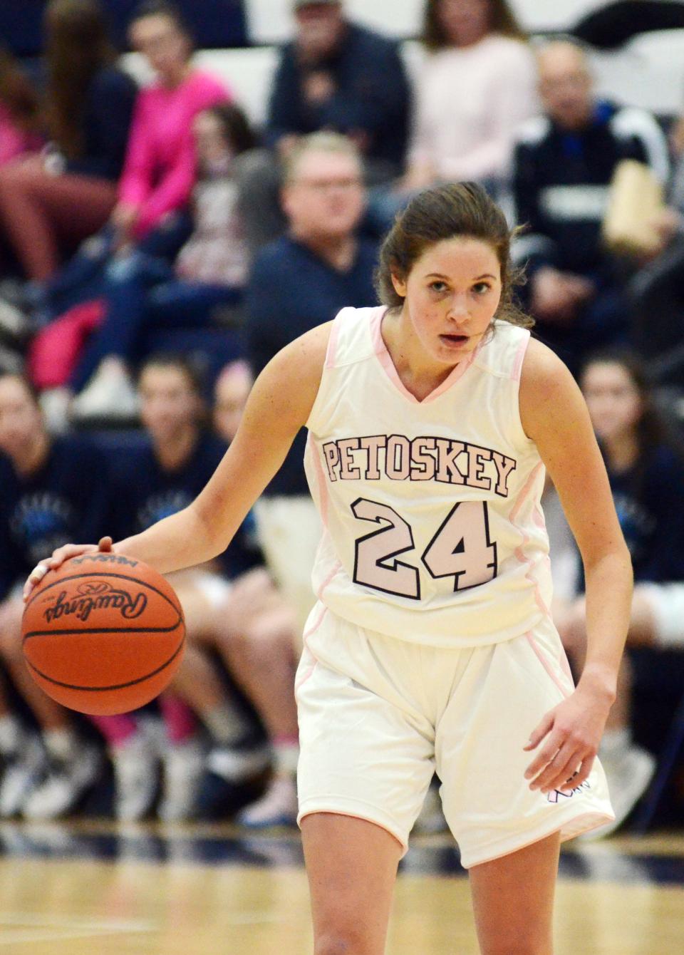 A determined Caroline Guy looks over the defense and waits on a teammate to break open in the first half.