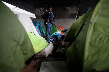 A migrant woman dresses up as French police evacuate hundreds of migrants living in makeshift camp set up under the Porte de la Chapelle ring bridge in Paris, France, January 29, 2019. REUTERS/Benoit Tessier