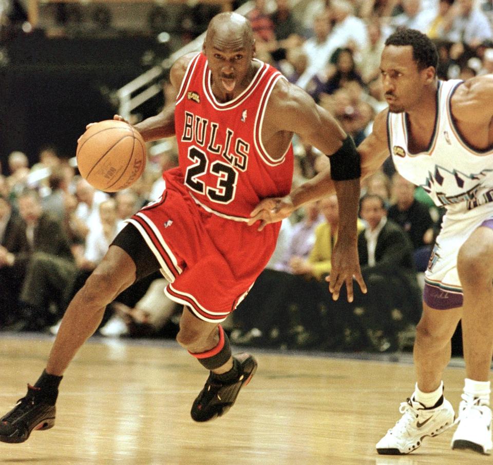 SALT LAKE CITY, UNITED STATES:  Michael Jordan (L) of the Chicago Bulls goes to the basket past Shandon Anderson of the Utah Jazz 14 June during game six of the NBA Finals at the Delta Center in Salt Lake City, UT. The Bulls lead the best-of-seven series 3-2.        AFP PHOTO/Mike NELSON (Photo credit should read MIKE NELSON/AFP via Getty Images)