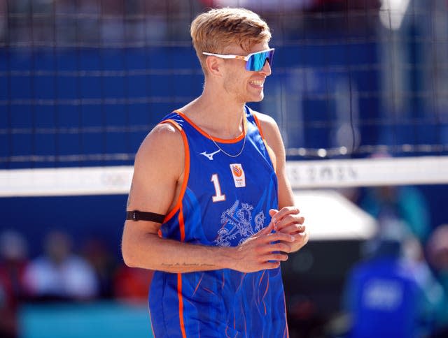 A smiling Steven van de Velde in action at the beach volleyball. 