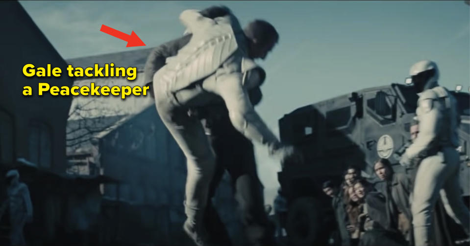 Gale from "The Hunger Games: Catching Fire" tackling a guard with the caption "Gale tackling a Peacekeeper"