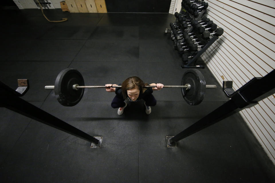 Melissa Breaux Bankston, a CrossFit athletic trainer at CrossFit Algiers in New Orleans, works out at the gym Monday, Dec. 23, 2019. She participates in an intermittent fasting diet. (AP Photo/Gerald Herbert)