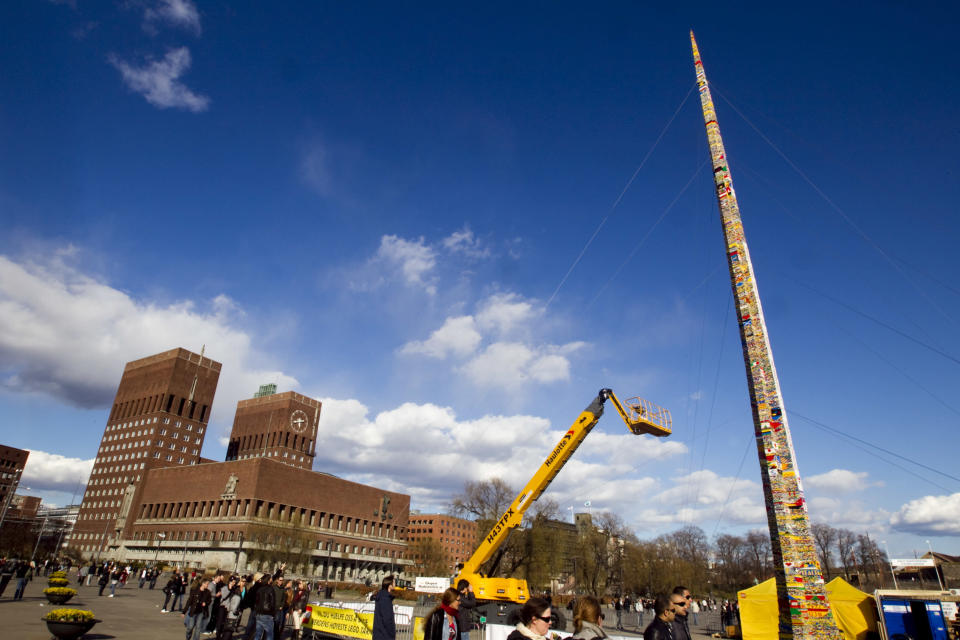 A tower created from Lego bricks is pictured completed in front of Oslo City Hall, April 24, 2010. It measures 30,22 meters and beats last year's record set in Munich by 25 centimetres, according to Norway's media. REUTERS/Scanpix/Heiko Junge