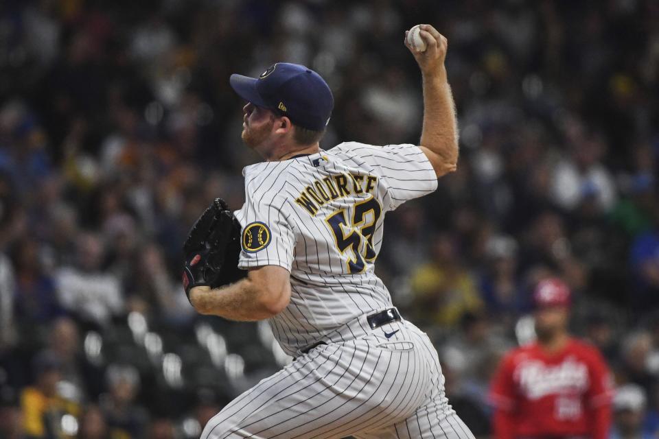 Milwaukee Brewers' Brandon Woodruff strikes out Cincinnati Reds' Donovan Solano during the first inning of a baseball game Sunday, Sept. 11, 2022, in Milwaukee. (AP Photo/Kenny Yoo)