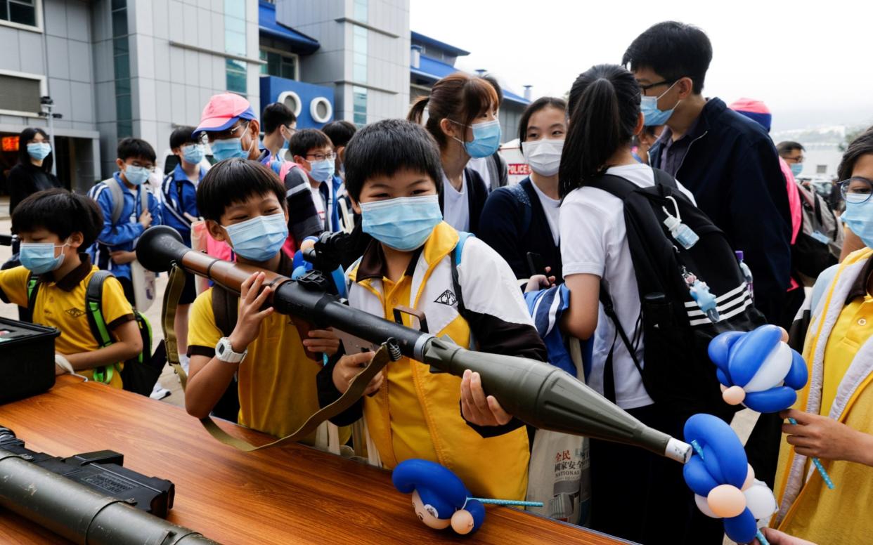 Children play with a mock rocket launcher at Hong Kong Police College - Reuters