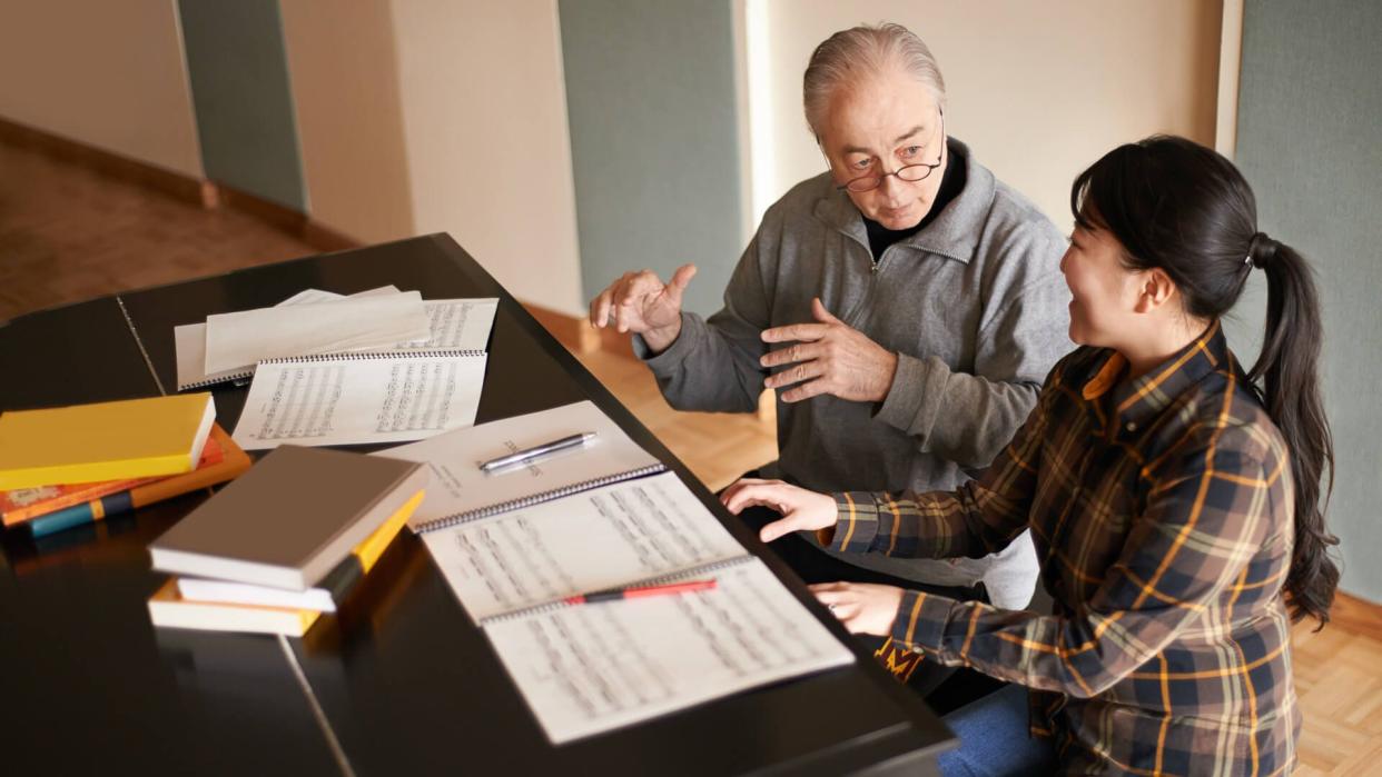 Shot of a piano teacher instructing a music studenthttp://195.