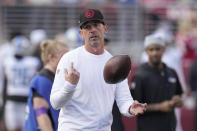 FILE - San Francisco 49ers head coach Kyle Shanahan watches players warm up before an NFL football game in Santa Clara, Calif., Jan. 28, 2024. The 49ers will no longer be spectators on the opening night of the NFL draft. After sitting out round one the past two years thanks to a pricey decision to trade up for failed quarterback Trey Lance in 2021, the 49ers will be in position to fill a hole on the roster on day one of the draft this year. (AP Photo/Mark J. Terrill, File)