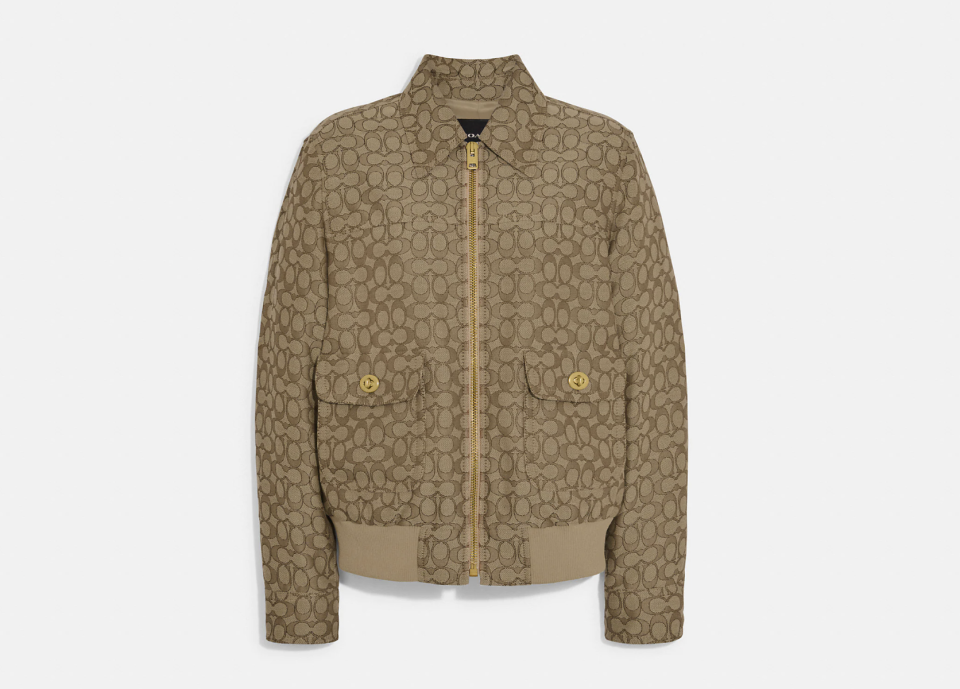 Coach Signature Jacquard Bomber in khaki multi (Photo via Coach Outlet)